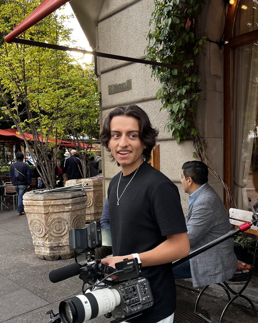 Kevin holding a cinema camera on set