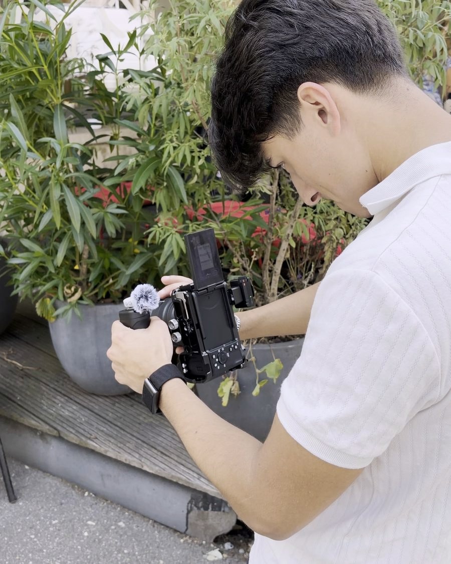 Kevin filming with a mirrorless camera outdoors